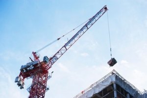 Crane loading equipment on building