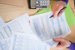 Man's hands filling his tax form